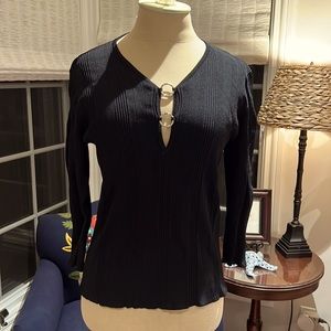 Black knit sweater with silver circles at neckline.
